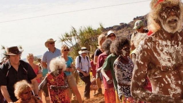 Indigenous Australian elders and others walking