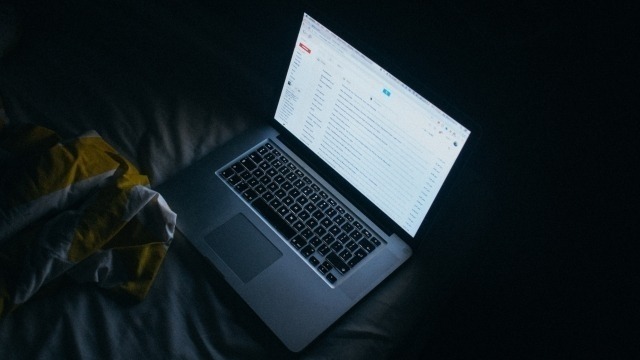 Laptop open in a dark room